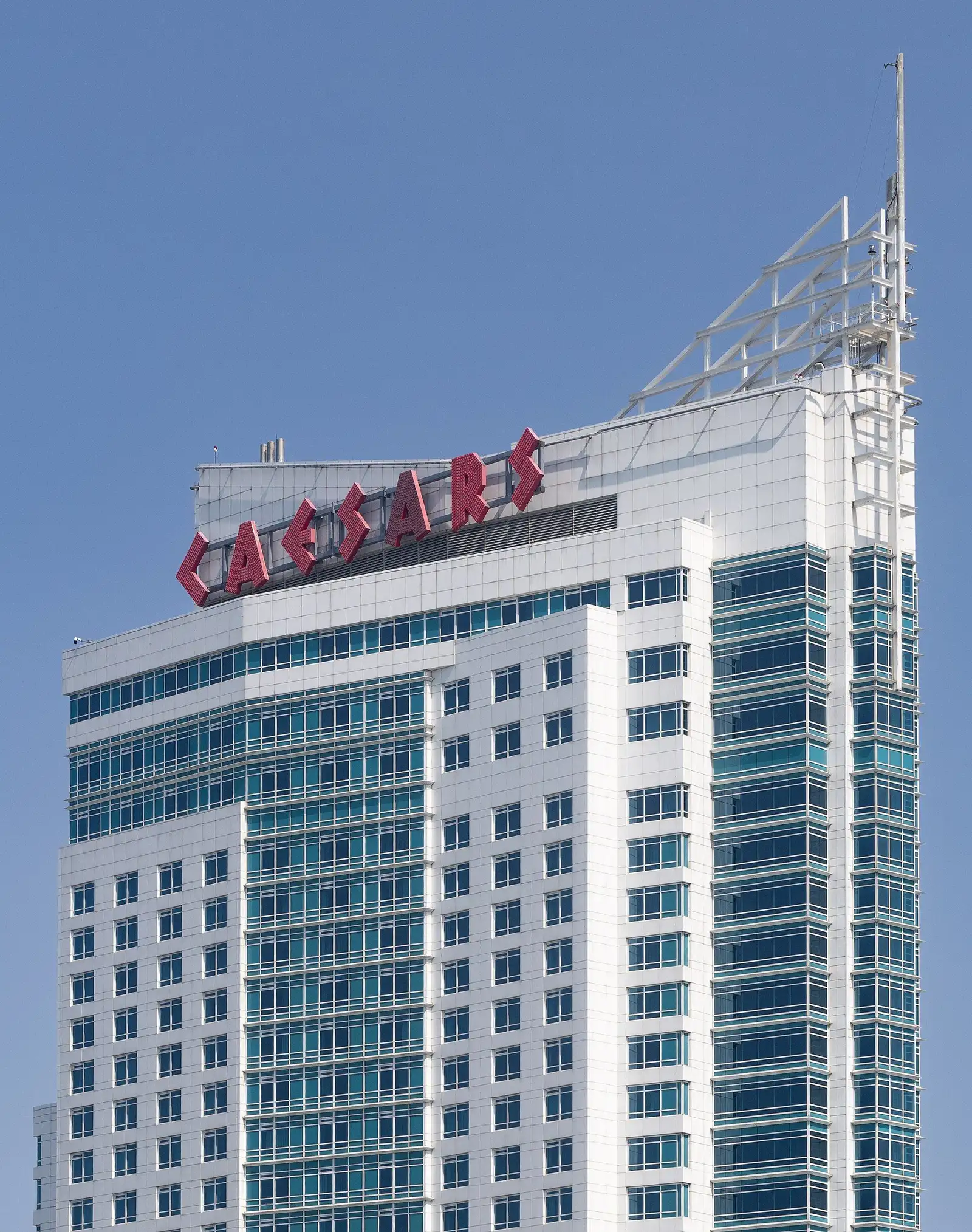 Casino hotel tower seen from below, with the rooftop Caesars sign — Caesars Windsor