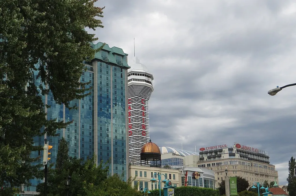 The Casino Niagara tower, marked with vertical red CASINO lettering, beside the Sheraton on the Falls glass tower and the Crowne Plaza on Falls Avenue in Niagara Falls, Ontario — Casino Niagara