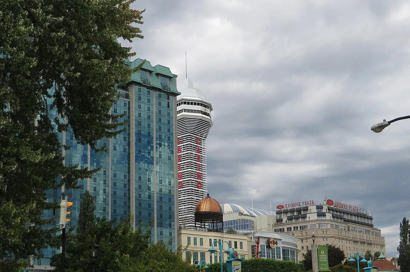 The Casino Niagara tower, marked with vertical red CASINO lettering, beside the Sheraton on the Falls glass tower and the Crowne Plaza on Falls Avenue in Niagara Falls, Ontario — Casino Niagara