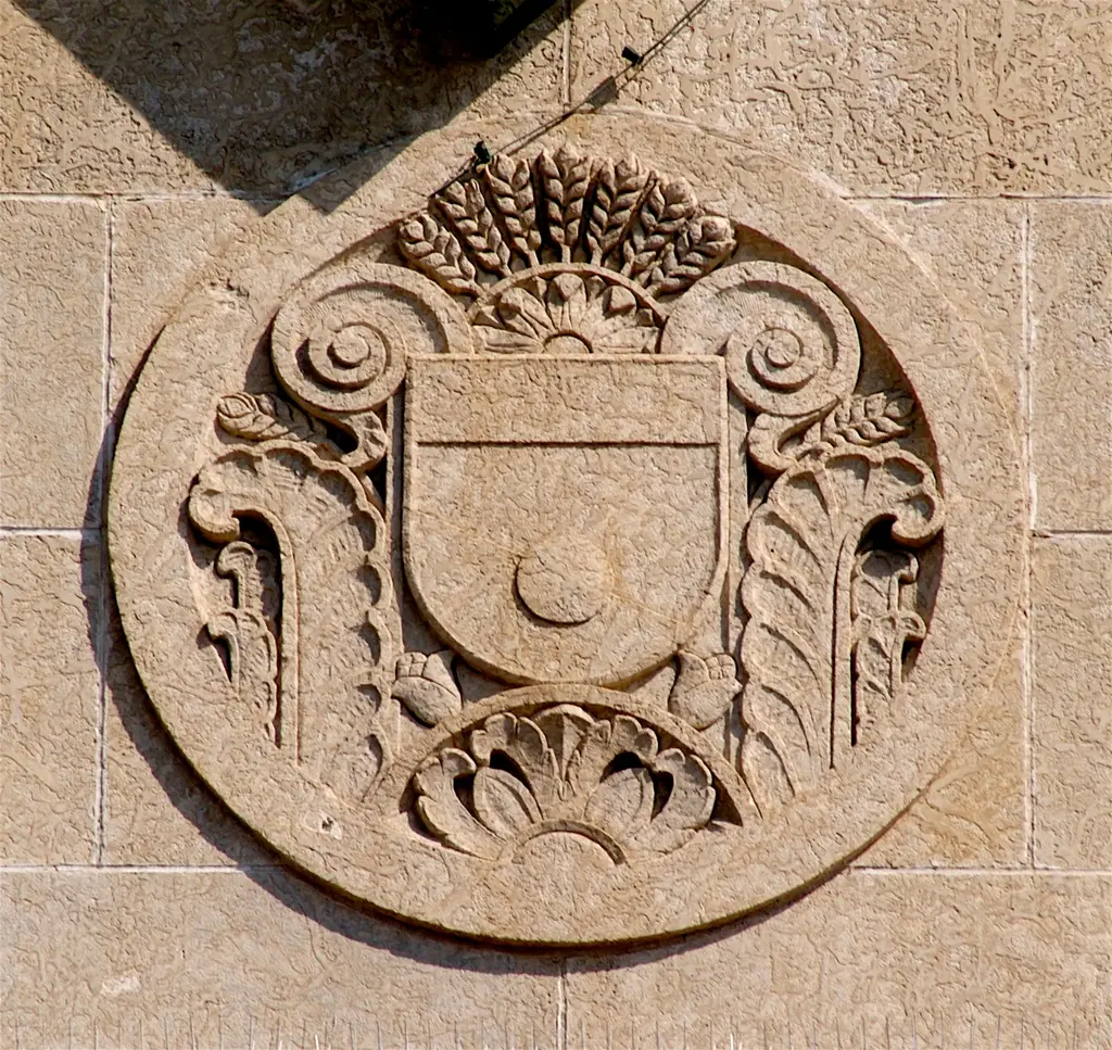 Carved stone roundel with a shield and wheat sheaves on the former Union Station, now Casino Regina — Casino Regina
