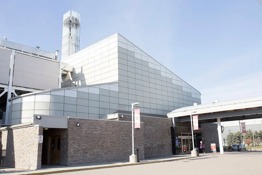 Metal-panelled facade above a stone base, with the canopied main entrance at right, Elements Casino Brantford — Elements Casino Brantford