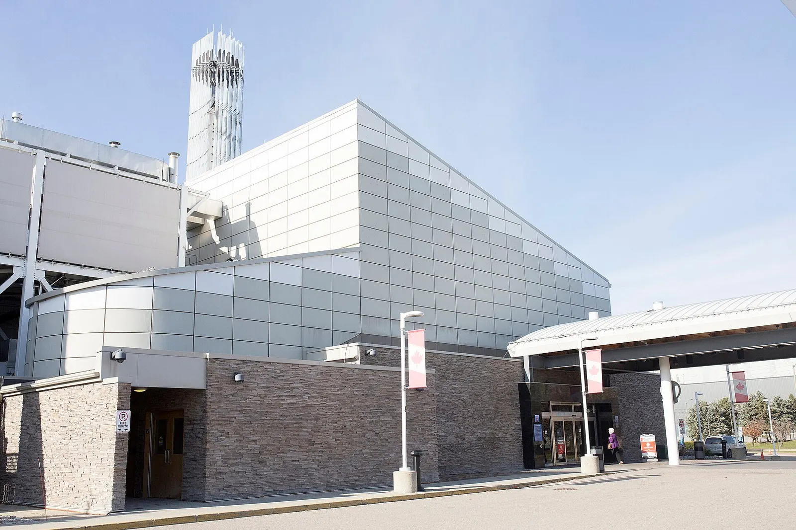 Metal-panelled facade above a stone base, with the canopied main entrance at right, Elements Casino Brantford — Elements Casino Brantford