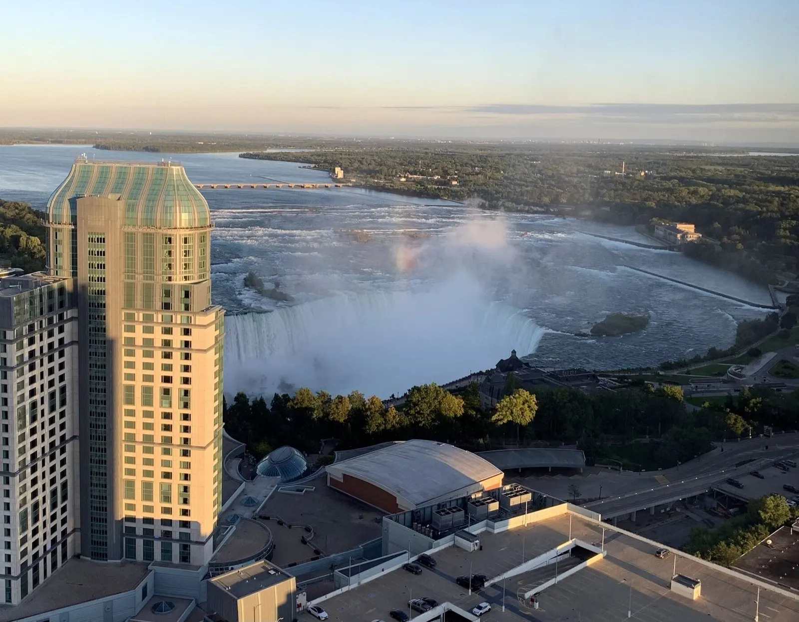 Fallsview Casino Resort hotel tower with the Horseshoe Falls and the upper Niagara River behind it — Fallsview Casino Resort