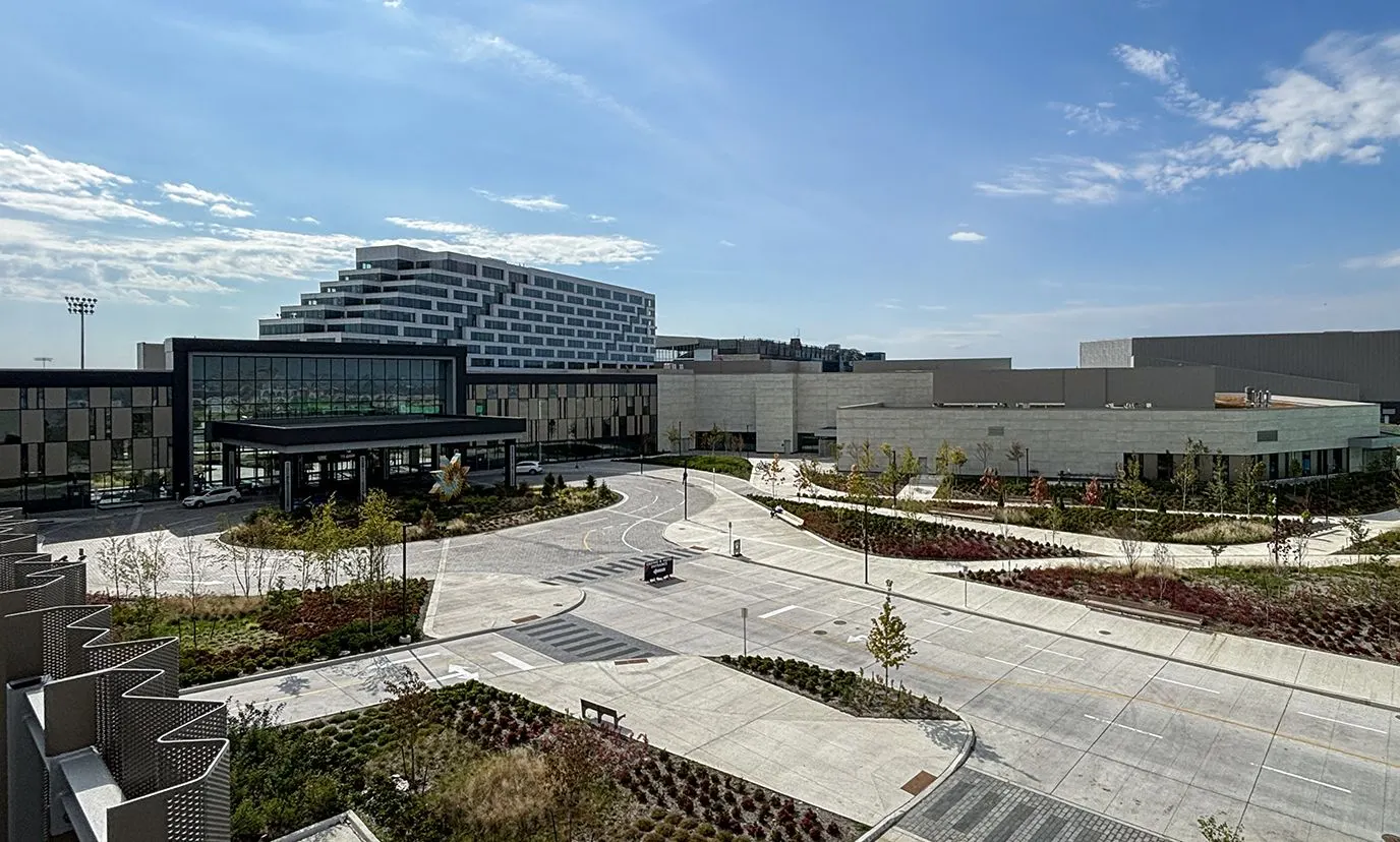 Great Canadian Casino Resort Toronto: the stepped hotel tower and the glass entrance pavilion under its canopy, with the lower casino buildings and the theatre block beyond the landscaped drop-off lanes — Great Canadian Casino Resort Toronto