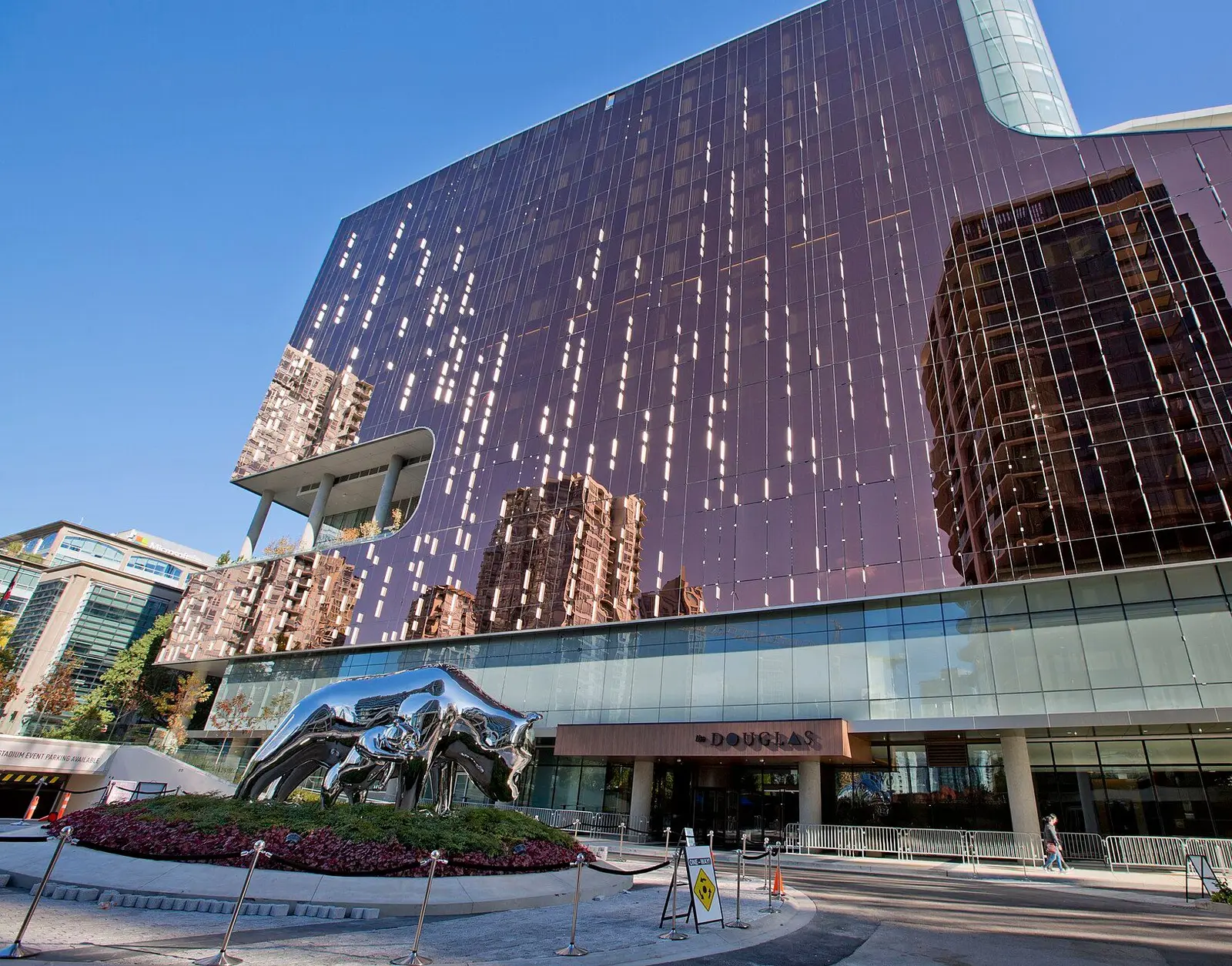 The Douglas entrance at Parq Vancouver, with a mirrored sculpture of two bears on the forecourt planter beneath the glass tower. — Parq Casino