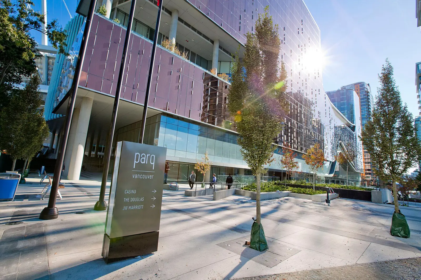 The Parq Vancouver complex seen from its plaza, with signage pointing the way to the casino — Parq Casino