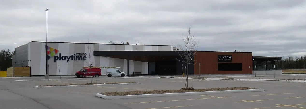 Playtime Casino Wasaga Beach by day, seen across its parking lot, with the MATCH Eatery & Public House wing on the right — Playtime Casino Wasaga Beach